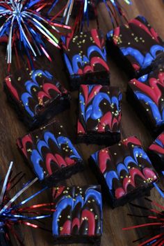 chocolate brownies with red, white and blue swirled icing on a wooden table