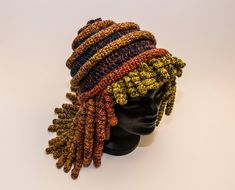 a mannequin head wearing a multicolored knitted hat