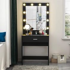 a black vanity with lights on it and a mirror in the corner next to it