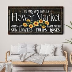 a sunflowers sign is hanging on the wall above a couch