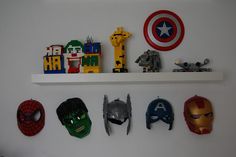 there are many masks on the shelf above the bed and in the wall behind them