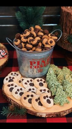 some cookies and other treats are on a table with a tin full of chocolate chip cookies