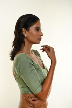 Discover timeless elegance with the Sap Green Elbow Sleeve Organza Blouse, featuring a deep U neckline and a front button hook closure in a matching color. This versatile piece offers a blend of understated charm and sophistication, making it the perfect accent for any saree. Elevate your wardrobe with this classic addition—shop now! Ruffle Saree, Organza Blouse, Cotton Gowns, Net Lehenga, Indo Western Dress, Peacock Green, Elbow Sleeve, Elbow Length Sleeve, Green Silk