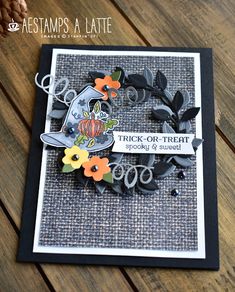 a close up of a card on a wooden table with scissors and flowers in it