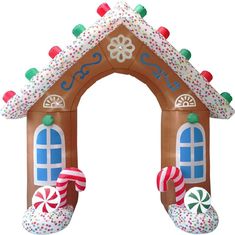 an inflatable gingerbread house with candy canes and candies on it