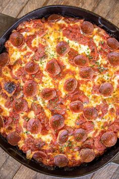 a large pepperoni pizza sitting on top of a pan