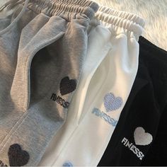 Stay Comfy and Stylish with Heart Embroidery Sweatpants! ❤️👖 🌟 Casual and Cute: Our sweatpants are designed for those who appreciate the charm of casual fashion and want to make a style statement that's both comfortable and complete. Ideal for individuals who love to blend fashion and comfort effortlessly. ✨ Superior Quality: Crafted with precision to ensure top-notch quality and comfort. These sweatpants are designed to keep you looking stylish and comfortable, whether you're lounging at home Trendy Embroidered Cotton Pants, Trendy Cotton Sweatpants, Casual Embroidered Winter Bottoms, Casual Embroidered Pants For Loungewear, Trendy Letter Print Pants For Winter, Trendy White Sweatpants For Winter, Trendy Pants With Letter Print For Winter, Trendy Cotton Joggers, Trendy White Winter Sweatpants