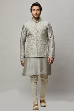 Cotton Linen blended kurta with floral ivory thread & gold sequence intertwined embroidered vest plus ivory churidar. The cotton-linen blend makes it one of our lightest and most breathable kurtas. Crafted with a collar neckline, full sleeves, and front button closure. Occasion: Can be worn to events like Sangeet, Mehendi, & Wedding WASH CARE INSTRUCTIONS - Please Dry clean only when it is applicable. Slight color variation is possible due to digital photography. Festive Raw Silk Nehru Jacket For Spring, Spring Festive Raw Silk Nehru Jacket, Spring Wedding Nehru Jacket In Raw Silk, Transitional Nehru Jacket With Gold Embroidery, Churidar, Full Sleeve, Digital Photography, Cotton Linen, Linen Blend