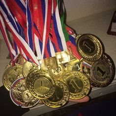 a person holding several medals in their hands