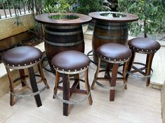 four brown stools and three wooden barrels