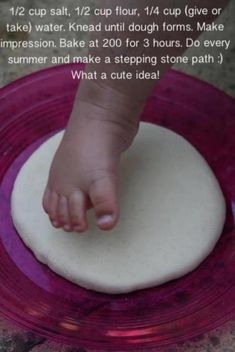 a baby's foot on top of a pink plate with the caption below it