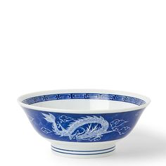 a blue and white bowl with dragon designs on it