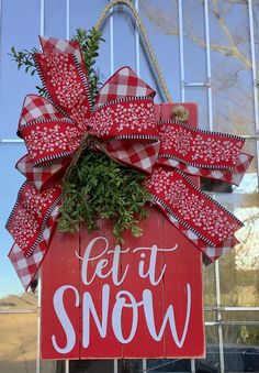 a red and white sign that says let it snow