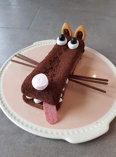 a piece of cake on a plate with sticks sticking out of it's mouth