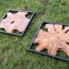 two wooden trays sitting on top of green grass