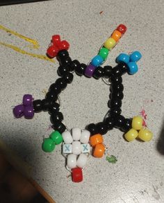 a bunch of beads that are sitting on a counter top with one bead in the shape of an x