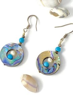 These earrings are a beautiful way to carry a piece of the sea with you wherever you go. The dangle design showcases the unique iridescence and natural beauty of the Abalone shell with shimmering blues, greens, and hints of pink.  The silver tone ear wires are for those with pierced ears and the turquoise and natural Pearl beads compliment the abalone perfectly. The measurements are 2" inches dangle length and 3/4" inches wide. TO VIEW MORE FROM NEW VINTAGE FOR YOU, GO HERE: https://newvintageforyou.etsy.com All vintage items are sold as is in pictured condition. I do not alter or repair any vintage items because I feel it is important to maintain the authentic history of the piece. The photos are images of the actual item that will be shipped. Please view the photos as they are part of th Boho Drop Earrings, Seashell Jewelry, Pearl Dangle Earrings, Natural Pearl, Pearl Earrings Dangle, Shell Earrings, Etsy Earrings Dangle, Abalone Shell, Natural Pearls