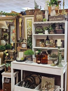 a room filled with lots of different types of furniture and decor on display in front of mirrors