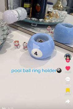 a pool ball ring holder is on the counter next to some bottles and glasses,