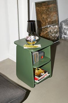 a small green table with magazines on it