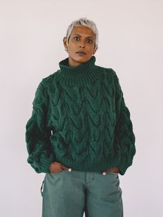 Relaxed, chunky, cropped sweater with mock turtleneck and dropped shoulders. Hand knit in a large Chevron pattern. Made in Peru. Preetha is 5'8” and wears a S/M. Chest: 35," Waist: 31." S/M, L/XL. Relaxed fit. 100% Organic Cotton. Dry Clean Only. Chunky Cropped Sweater, Cotton Turtleneck, Hand Knit Sweater, Green Hand, Hand Knitted Sweaters, Mock Turtleneck, Knitwear Tops, Chevron Pattern, Sweatshirt Dress