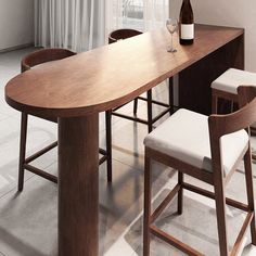 a wooden table with two stools and a bottle of wine