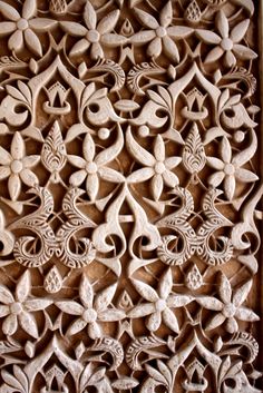 an intricately carved wooden panel with flowers and leaves