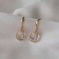 🤍 BLANCA PETITE Gold Crystal Dropper Earrings 🤍 Petite version of our best selling Blanca earrings.  The Blanca petite earrings are stunningly sparkly crystal drop earrings, a perfect addition to any outfit. The white crystal teardrop is encased with a gold edging & then added to a subtle gold ear hook. Available in 14ct gold vermeil or sterling silver. Details: 14ct gold vermeil or sterling silver White crystal  Crystal size 13mm x 9mm ♻️Sustainable jewellery - our jewellery is made with recycled metals and responsibly sourced stones. If you would like some help choosing your bridal accessories, please get in touch with us and we will be happy to help.  Deborah K Design is an award winning bespoke bridal accessories designer based in the UK, offering worldwide shipping. Our collections Feminine Wedding Earrings, Wedding Jewelry Ideas For Bride, Drop Bridal Earrings, Gold Teardrop Earrings, Gold Minimalist Jewelry, Earring Stack, Petite Earrings, Gold Earrings Wedding, Earrings Minimal