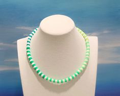 This is The Outer Shore Collection Green Ombré Beaded Heishi necklace. This boho tropical surf style necklace is inspired by the Choker necklaces that Kiara wore on the Netflix series The Outer Banks. This necklace is perfect for wearing alone, or stacking with others. Necklaces are handmade to order and offered in a variety of styles. I've provided a size guide in the photos to help you determine your desired length. Orders are made and shipped within 1-2 business days after your order is shipp Cheap Green Necklace With Heishi Beads, Kiara Outer Banks, Bead Choker Necklace, Heishi Necklace, Beach Necklace, Bead Choker, Beach Necklaces, Green Ombre, Surf Style