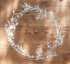 a wooden table topped with a metal wreath