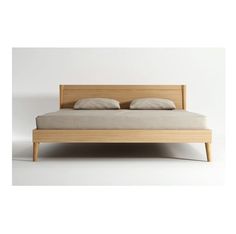 a bed with two pillows on top of it and a wooden headboard in the middle