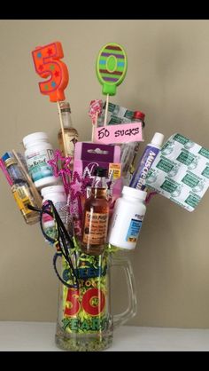 a glass vase filled with lots of different types of medicine and personal care items on top of a table