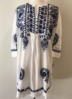 Navy blue hand embroidered white tunic dress for your Bohemian soul. 100% cotton button front hand wash handmade in India MEASUREMENT CHART Cheap Bohemian Embroidered Hem Dress, Arshi Khan, Ladies Kurta, Hand Embroidered Tunics, White Tunic Dress, Cotton Tunic Tops, Bohemian Soul, Kurta Design, Embroidered Tunic Top