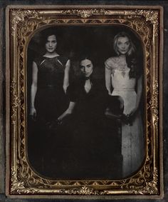 an old photo of three women in black and white