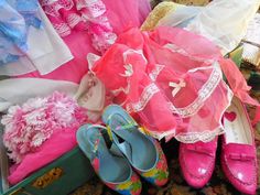 several pairs of pink shoes are sitting on the floor