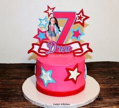 a pink and red birthday cake with the number seven on it's bottom tier