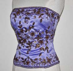 *-----ALL SALES FINAL NO REFUND NO EXCHANGE----* *-JTRIMMING Vintage Bustier Corset Hand Work Gotta Thread Embroidery On Satin Style 3128 *-Vintage Production *-Color: Violet/Copper (As Picture), White/Copper (As Picture) *-Available Size *-Regular: 2-4-6-16-18 *-Bustier: Sleeve Less Hand Work Gotta Thread *-Country/Region of Manufacture: India *-Decade: 1980s *-Occasion: Wedding, Mother of Bride, Cocktail, Prom, Bride Made, Evening, Party, Formal *-All Season Sizes Chart Size: -(2)----(4)---(6) Purple Fitted Wedding Corset, Wedding Mother Of Bride, Beaded Bolero, Vintage Bustier, Embellished Crop Top, Russia Travel, Satin Style, Color Violet, Corset Bustier