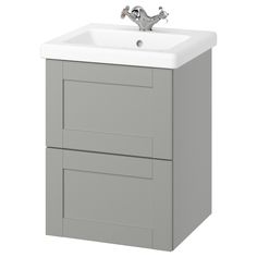 a white sink sitting on top of a gray cabinet next to a faucet