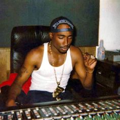 a man sitting in front of a mixing desk