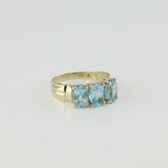 "10K Yellow Gold Blue Topaz 3 Stone Ring, 3 6x8mm deep blue oval faceted topaz stones, fluted lobed shoulders top shank, pierced sides, 7/32\" across, Ring size 8, Circa 1990, 3.6 grams SKU# BB244R17 This listing contains photographs of the actual item you will receive. Our items are in excellent condition with little or no signs of wear and many are one of a kind pre-owned estate finds. Please look closely at the pictures in this listing as they are part of the product description. Please read 3 Stone Ring, Sparkly Ring, Gold Diamond Band, 3 Stone Rings, Topaz Stone, Yellow Gold Earring, Fine Jewelry Designers, Blue Topaz Ring, Topaz Ring