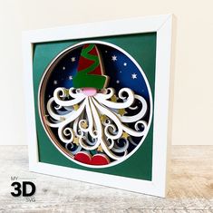 an ornament with a christmas tree on it in a white frame and green background