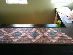 an old dresser is covered with mosaic tiles