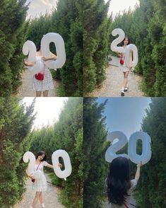 the woman is holding two large balloons in front of her face and number 20 on it