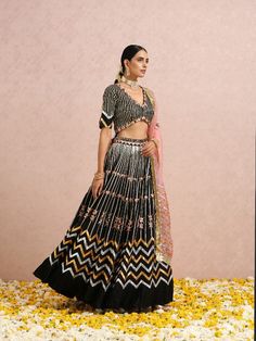 Featuring a black embroidered lehenga in silk base. It is paired with a black embroidered blouse and comes with a coral silk organza dupatta Color: Black and Coral Pink Fabric: Lehenga & Blouse - Silk base Dupatta - Silk Organza Note: The product will be shipped within 30-35 days of order placed Wash care - Dry Clean Only. Do not use heavy Iron Black Sharara For Reception During Navratri, Black Traditional Wear With Sequins, Black Sharara With Intricate Embroidery For Reception, Black Lehenga With Intricate Embroidery, Black Silk Traditional Wear With Mirror Work, Traditional Black Lehenga With Intricate Embroidery, Black Silk Dupatta For Reception, Designer Black Sharara With Cutdana, Designer Black Lehenga With Traditional Drape