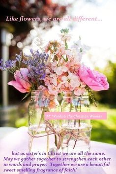 a vase filled with flowers sitting on top of a table next to a pink sign