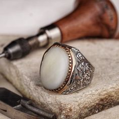 Adorn your hand with the timeless elegance of this handcrafted silver ring, featuring a natural mother-of-pearl stone set in a large oval bezel. The iridescent sheen of nacre is said to bring calming and soothing energies, symbolizing purity and spiritual transformation. This luxurious piece stands out for its serene beauty and the gentle luster that reflects light in a play of colors. * Discover our handmade Agate stone minimal ring in silver natural gemstone classic men accessory sterling silv University Symbol, Minimal Ring, Spiritual Transformation, Handmade Silver Ring, Pearl Stone, Mens Silver Rings, Silver Engraving, Silver Rings Handmade, Silver Man