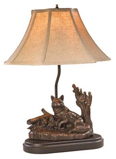 a lamp that is sitting on top of a wooden base with a light shade over it