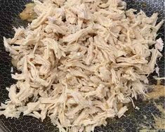 shredded chicken is sitting in a bowl on the stove top, ready to be cooked