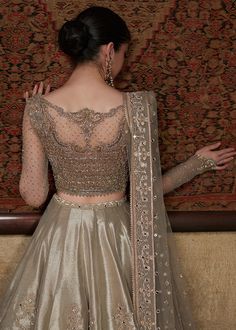 the back of a woman's dress in gold