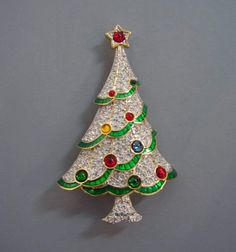 Handmade brooch This is a gorgeous silver Christmas tree shaped brooch. Metal- Sterling silver Diamond Wt - 2.99Ct Diamond Color - White Diamonds- American Diamonds Diamonds shape- Round Gemstone- Emerald,Ruby, Blue sapphire, Yellow topaz(Lab created) Dimension-- 3.5 inch Silver Wt - 14.25gm Silver Finish - White/Gold Plated Finished Silver Purity - 925 Sterling Silver Brooch Would you like to give a nice pin gift to your loved ones on New Year's Eve? With this Christmas Tree Brooch, you can giv Nordstrom Christmas, Brooch Christmas Tree, Swarovski Christmas Tree, Swarovski Christmas, Christmas Bling, Christmas Brooch, Silver Christmas Tree, Beautiful Christmas Trees, Sterling Silver Brooch